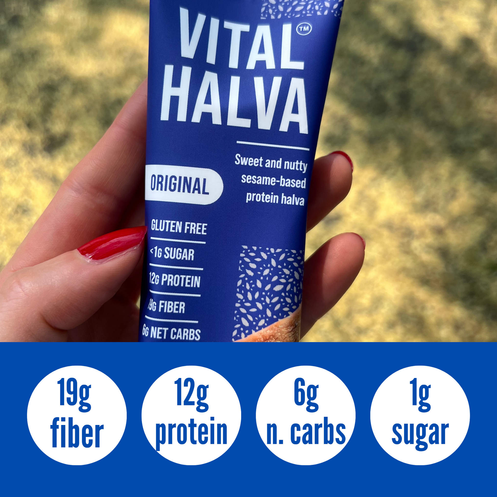 Hand holding a blue package of Vital Halva with nutritional information displayed.