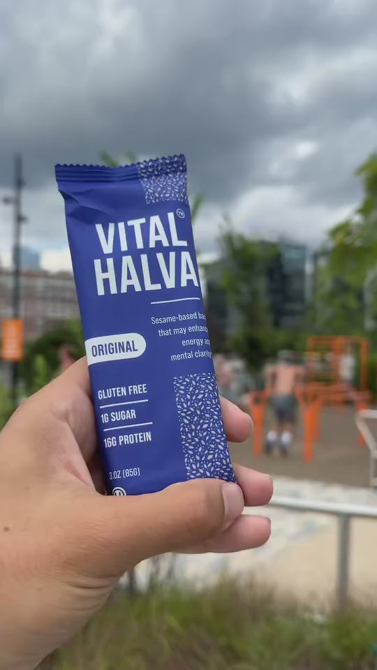 video of Vital Halva bar held up outside in a workout location, city